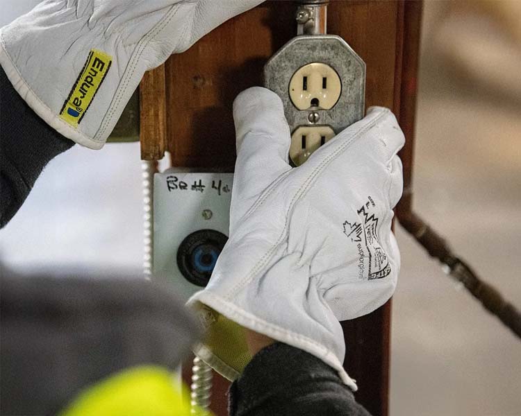 A worker wearing Superior Glove safety gloves while working in a construction site, ensuring protection and dexterity.