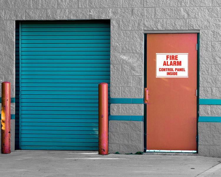 A door with a VisionMarker fire alarm sign, essential for fire safety and emergency preparedness in industrial settings.